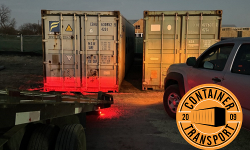 Two containers going on a trailer.