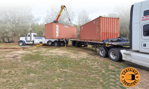 Two containers lifted by a crane on a trailer.