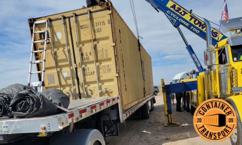 Crane putting a container on a trailer.