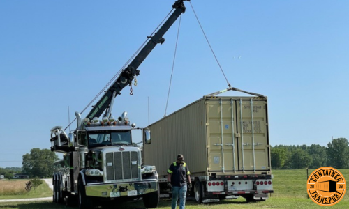 Crane lifting Container onto trailer.