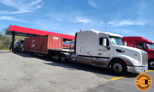 Transporting a 40ft loaded container on a step deck trailer.