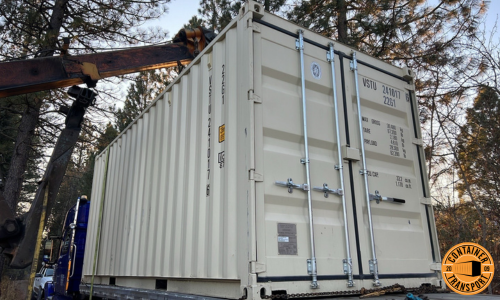 Container loaded on trailer by crane.