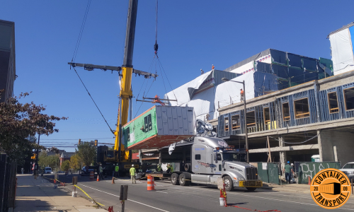 Crane unloading a Container on a trailer.