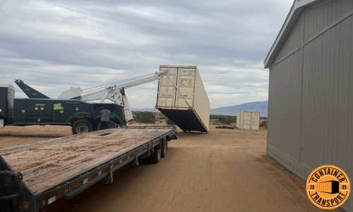 Crane loading Container onto a trailer for transport.