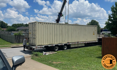 Crane loading a Container on a trailer for Transport.